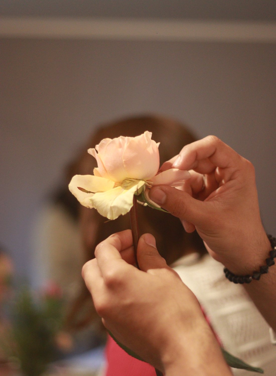 Manos aprendiendo a prensar flores en un taller